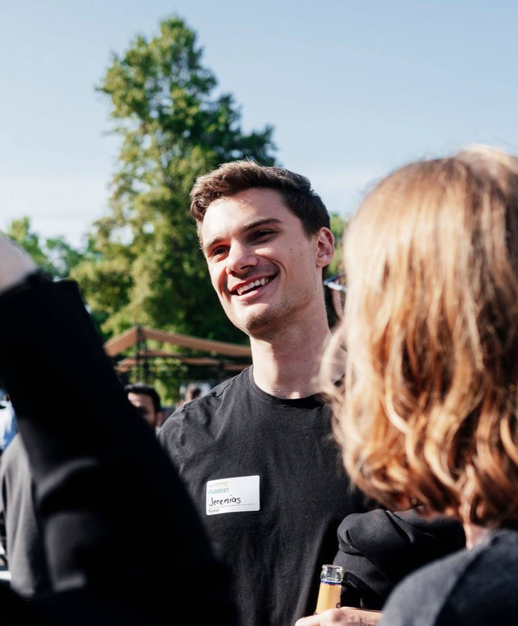 Jeremias smiling during an outdoor conversation